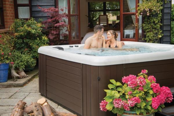 hot tub in garden with a couple